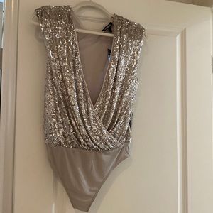 Gorgeous champagne color sequin bodysuit. New with tags. Smoke free home.